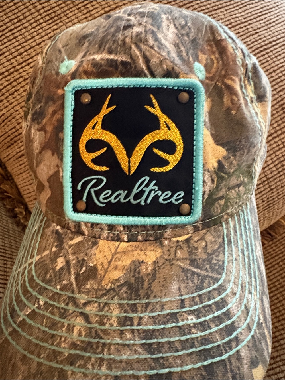 Realtree Camo Womans Hat with Mint Accents and Gold Logo